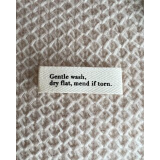 "Gentle wash, dry flat, mend if torn." Textiletikett
